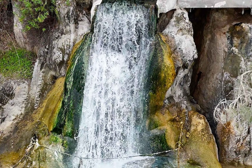 A waterfall cascading over moss-covered rocks. 2