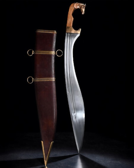 A scabbard with a wooden handle and a sword with a curved blade. 3