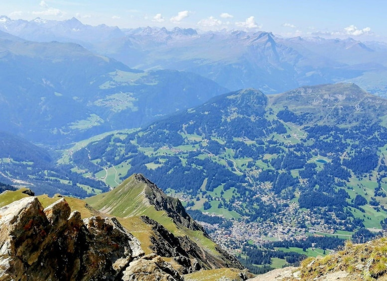 A mountainous landscape with a village nestled in the valley. 3