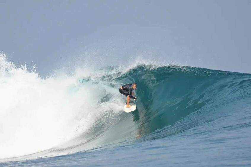 A surfer riding a large wave in the ocean. 2