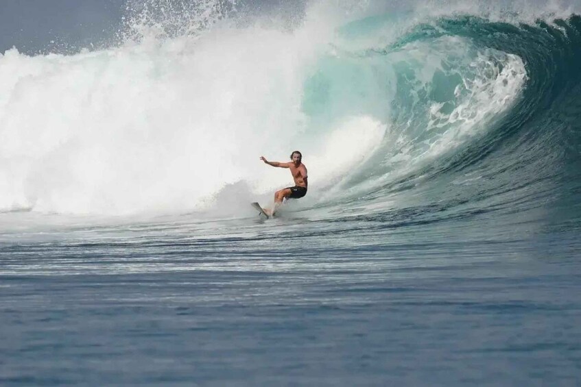 A surfer riding a large wave in the ocean. 1
