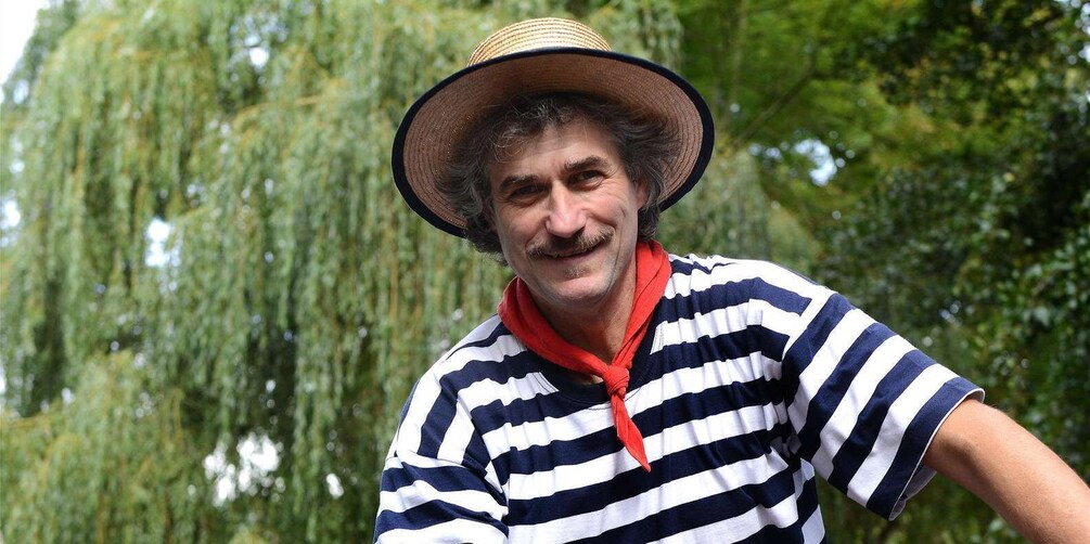 A person wearing a striped shirt and a straw hat. 4