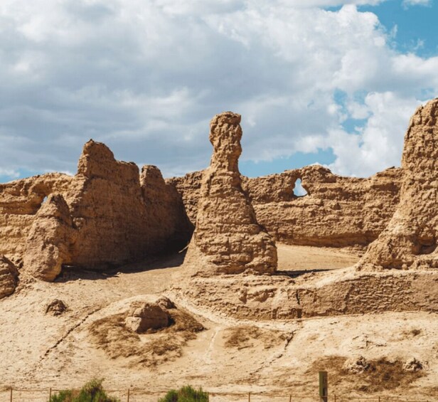 A desert landscape with eroded rock formations and a clear sky. 5