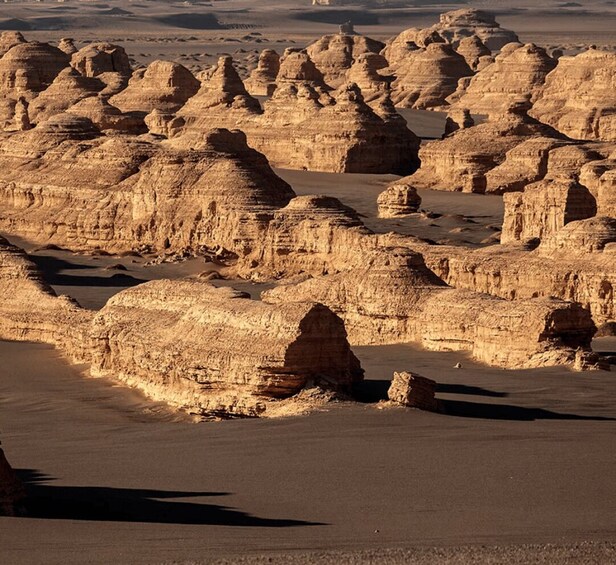A desert landscape with prominent rock formations and a flat terrain. 2