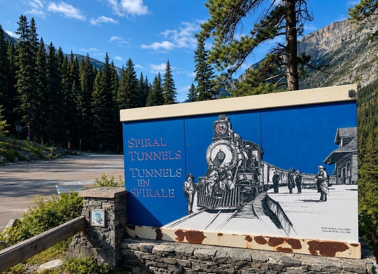A sign with 'SPIRAL TUNNELS' and a historical train scene illustration. 3
