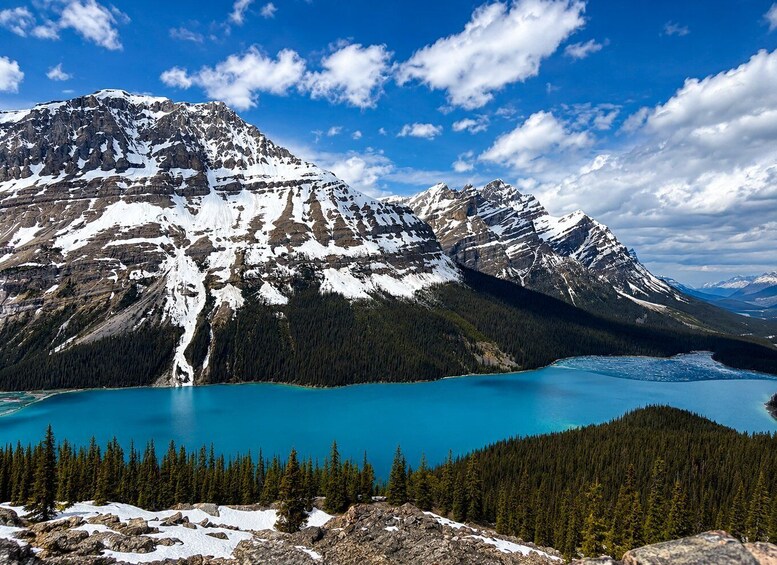 A mountain range with a turquoise lake at its base. 5