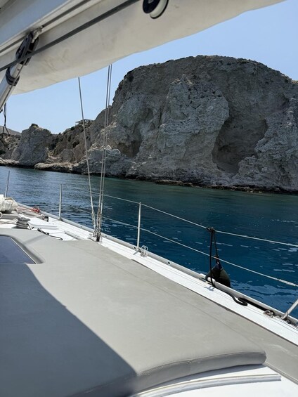 A boat with a rocky cliff in the background. 5
