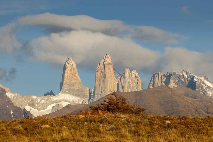 A mountainous landscape with prominent peaks and a clear sky. 3