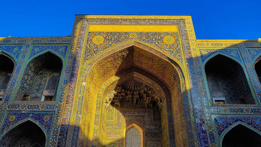 A detailed archway with intricate tile work and calligraphy. 5