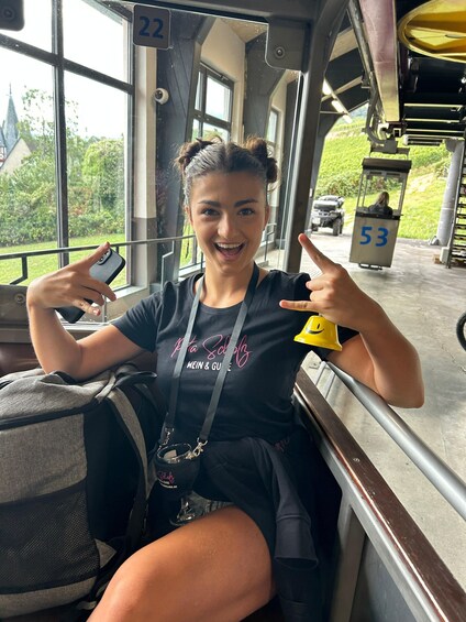 A person sitting on a bus with a window view of a golf course and a golf cart. 5