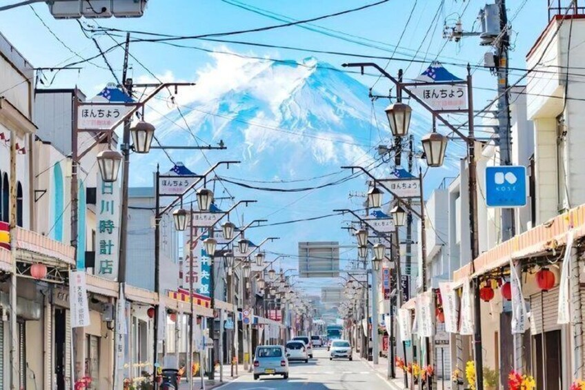 A street with shops, a mountain in the background, and power lines overhead. 2
