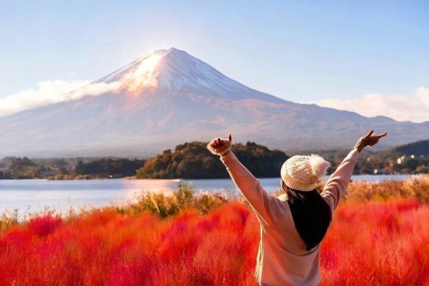 A person with arms raised facing a mountain. 5