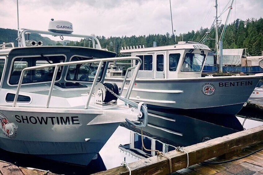Two boats docked at a marina with 'SHOWTIME' and 'BENTFIN' written on them. 2