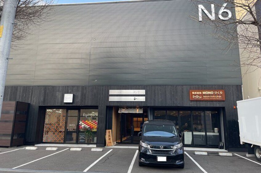 A building with a sign reading 'N6' and 'MONO つくの'. 3