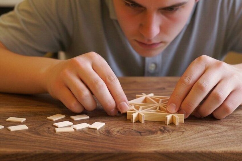 A person arranging wooden blocks on a table. 1
