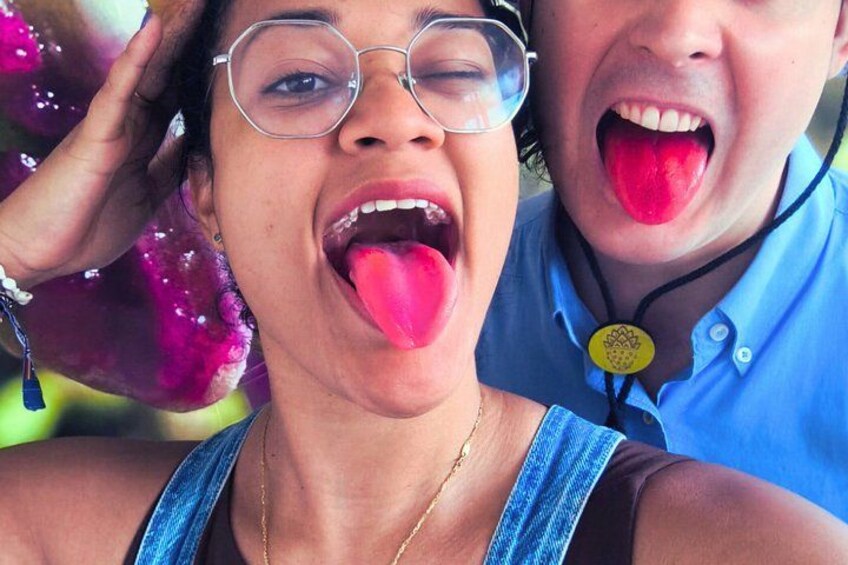 A person wearing a blue shirt with a yellow button and a necklace. 4