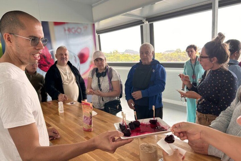 A group of people around a table with a cake and drinks. 2