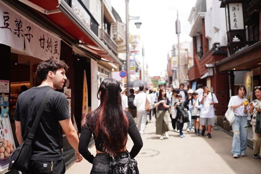A crowded street with shops and pedestrians. 1