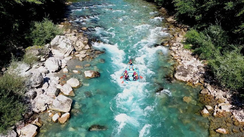 A river with rapids, surrounded by rocks and greenery. 1