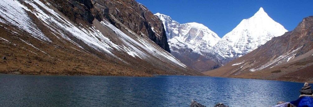 A mountain lake with snow-capped peaks and a clear blue sky. 3