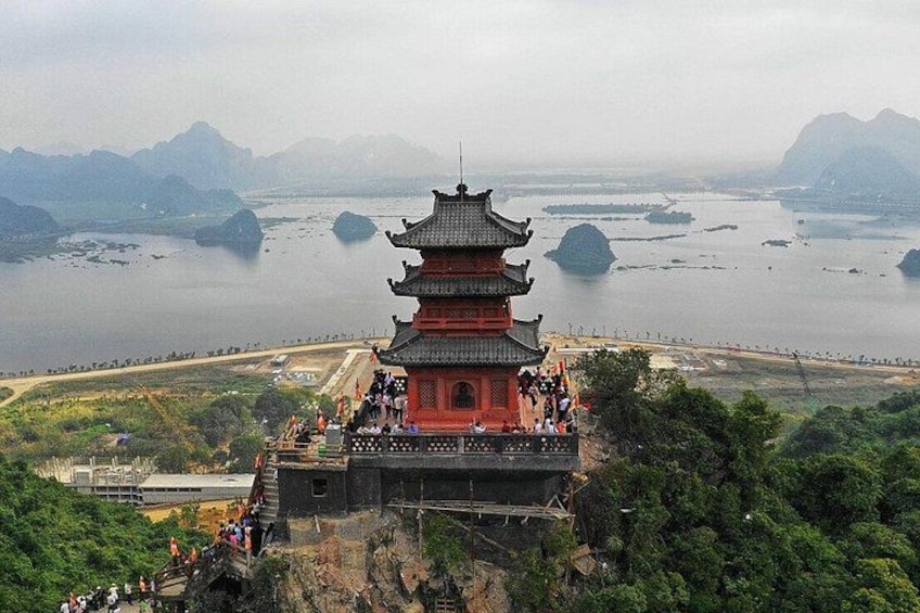 A pagoda with a view of a lake and mountains. 3