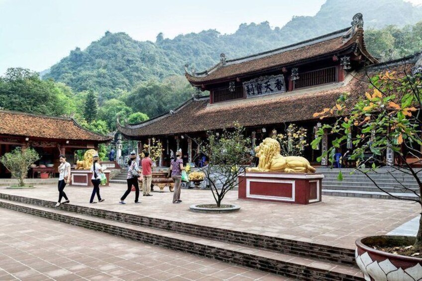 A traditional Chinese building with a lion statue in front. 5