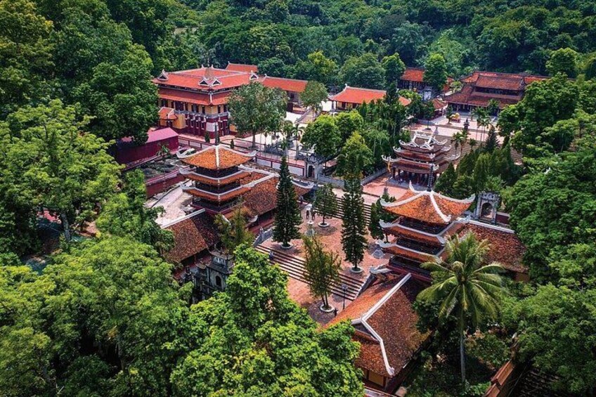 A traditional temple complex surrounded by lush greenery. 4