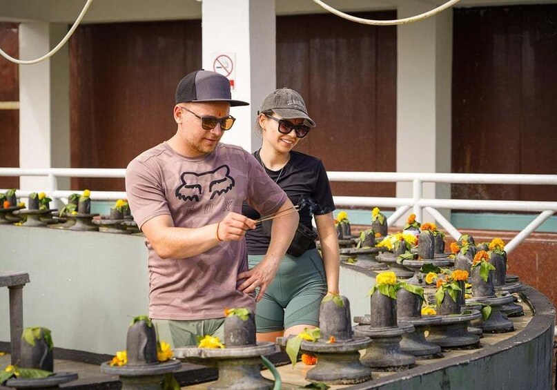 Two people tending to a garden with numerous flower pots. 3