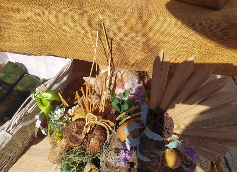 A basket with natural elements like wood, flowers, and leaves. 3