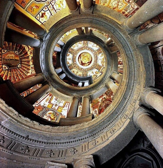 A grandiose, intricately decorated dome with a central circular design, surrounded by ornate columns and detailed frescoes. 1
