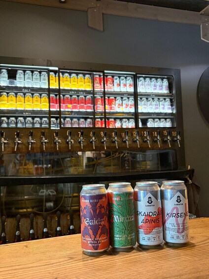 A selection of beverage cans in front of a refrigerated display with various drinks. 3
