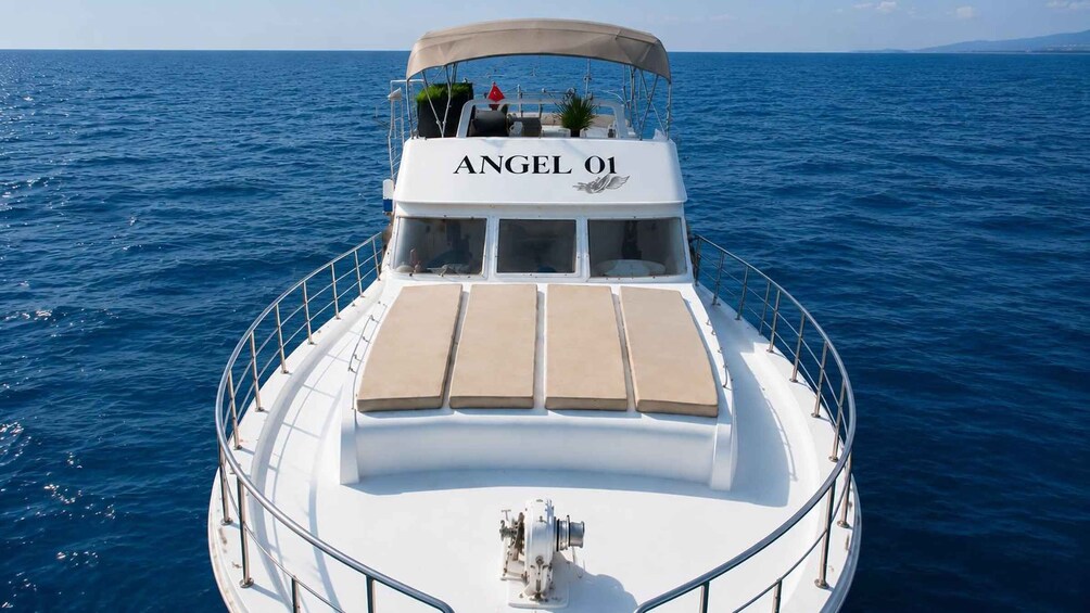 A boat named 'ANGEL 01' with a covered deck and lounge chairs. 4