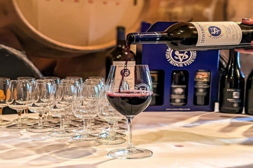 A bottle of wine being poured into a glass. 4