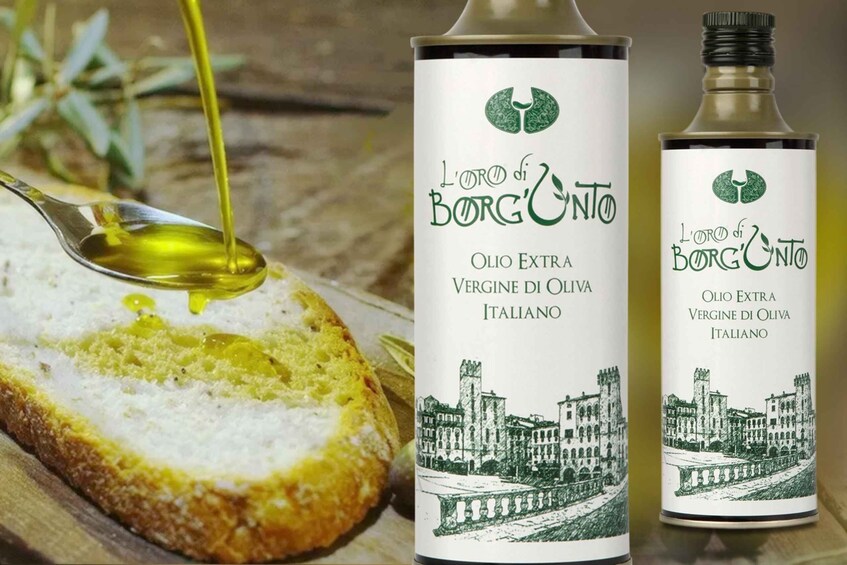 A bottle of extra virgin olive oil with a cityscape illustration and a spoon pouring oil onto bread. 2