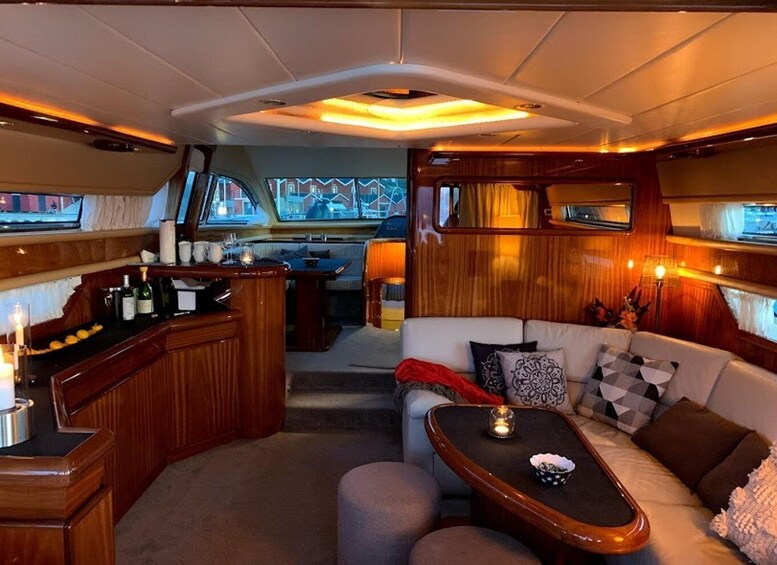 A yacht interior with a bar, seating area, and a view of the outside. 2