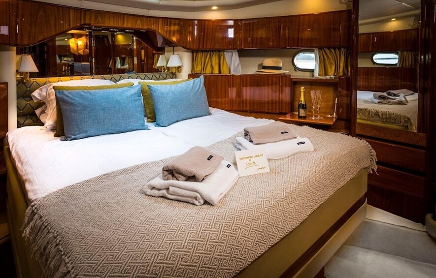 A well-appointed cabin with a large bed, wooden paneling, and a cozy atmosphere. 5