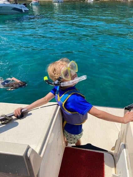 A child snorkeling on a boat. 4