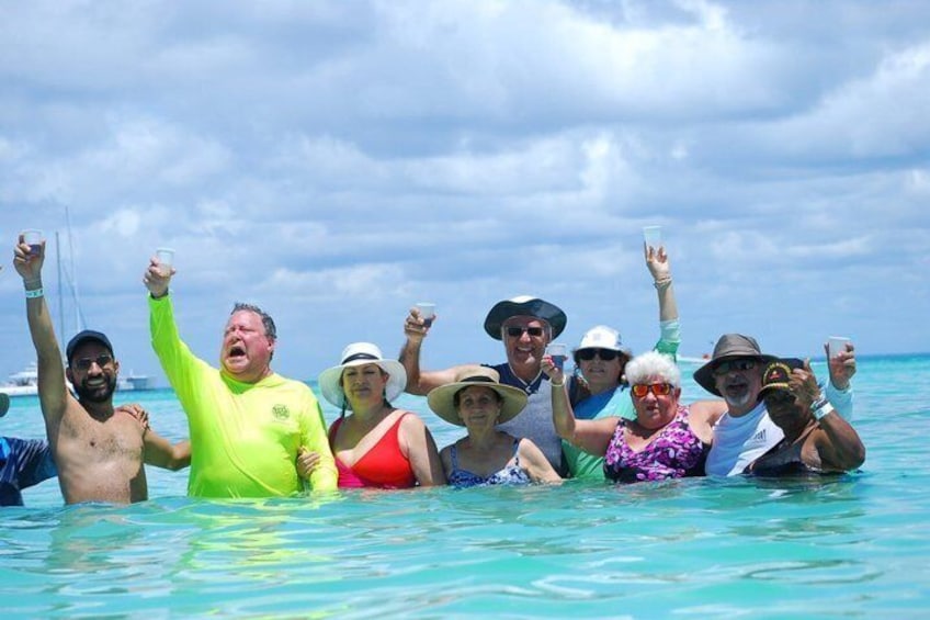 A group of people in a boat on turquoise water. 1