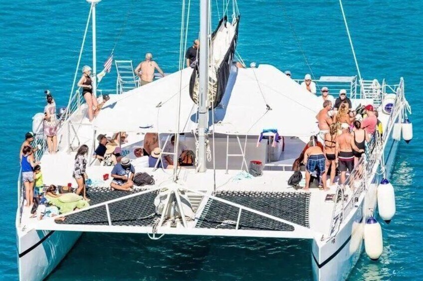 A boat with people on deck, surrounded by water. 1