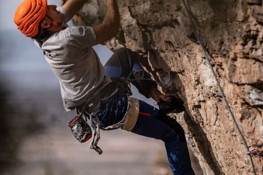 A person rock climbing on a rocky surface. 1
