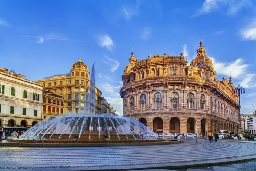 A historic building with ornate architecture and a central fountain. 3