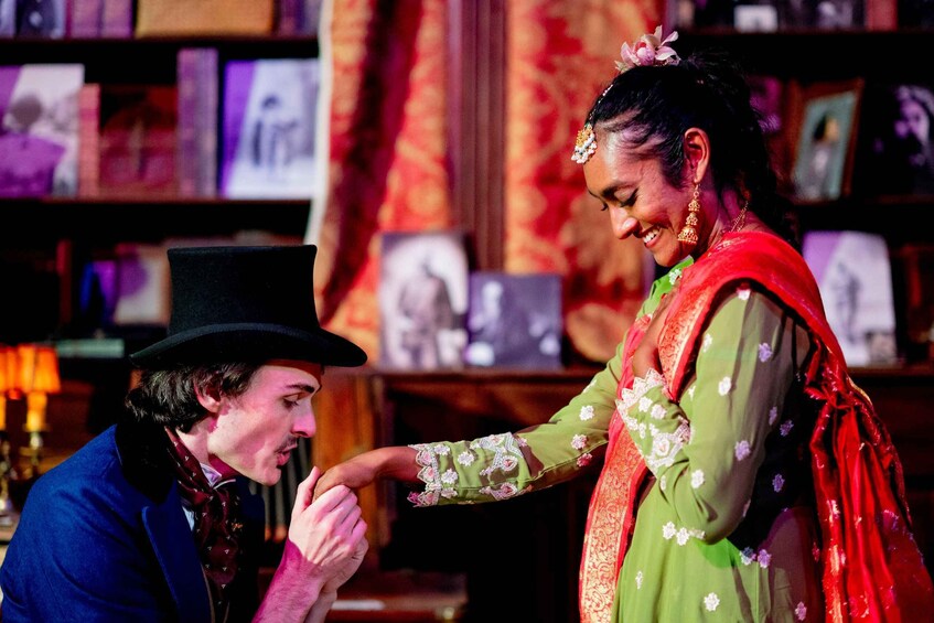 A man in a top hat and a woman in a green dress with floral embroidery. 1