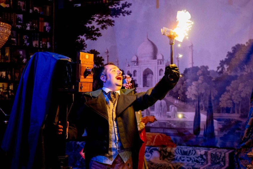 A person in a suit holding a torch with a flame, a bookshelf, and a backdrop of a domed building. 4