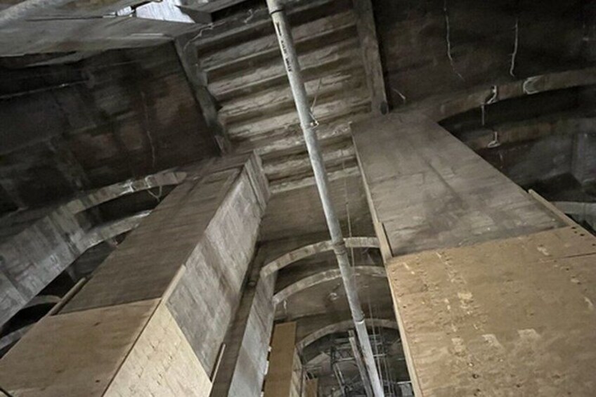 A construction site with exposed concrete structures and metal beams. 3