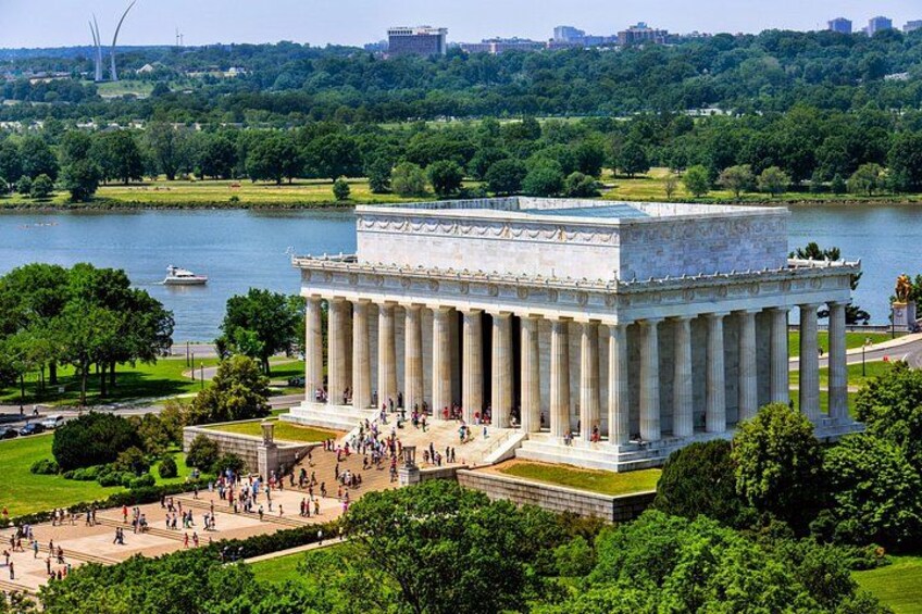 The Lincoln Memorial with a lake and trees in the background. 4