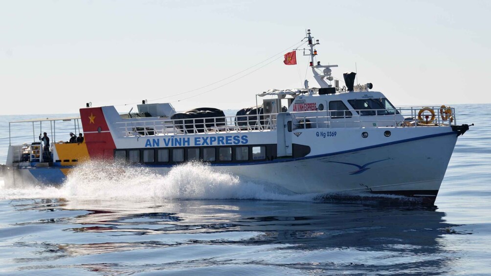 A white boat with 'AN VINH EXPRESS' on its side, moving through water. 3