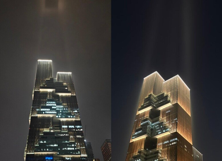 A tall, illuminated skyscraper at night. 3