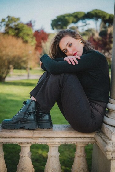 A person sitting on a stone bench outdoors. 4