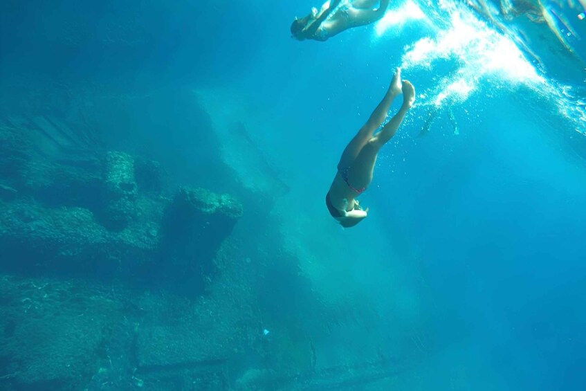 Two people swimming underwater. 5