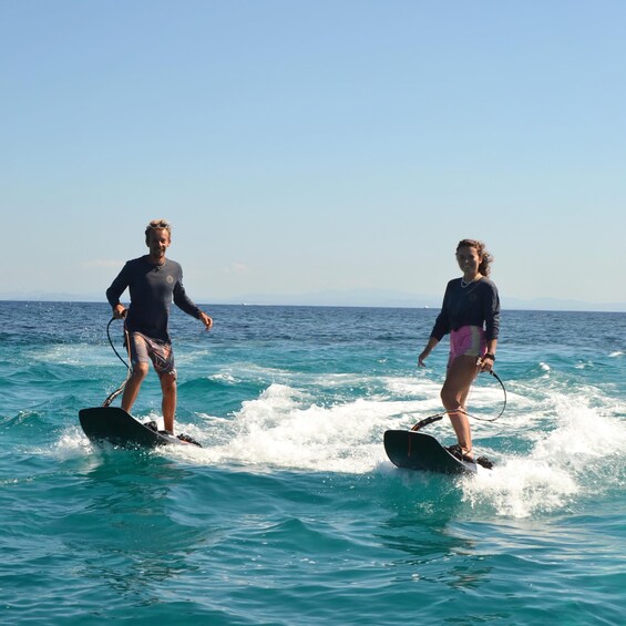 Two people wakeboarding on the ocean. 2